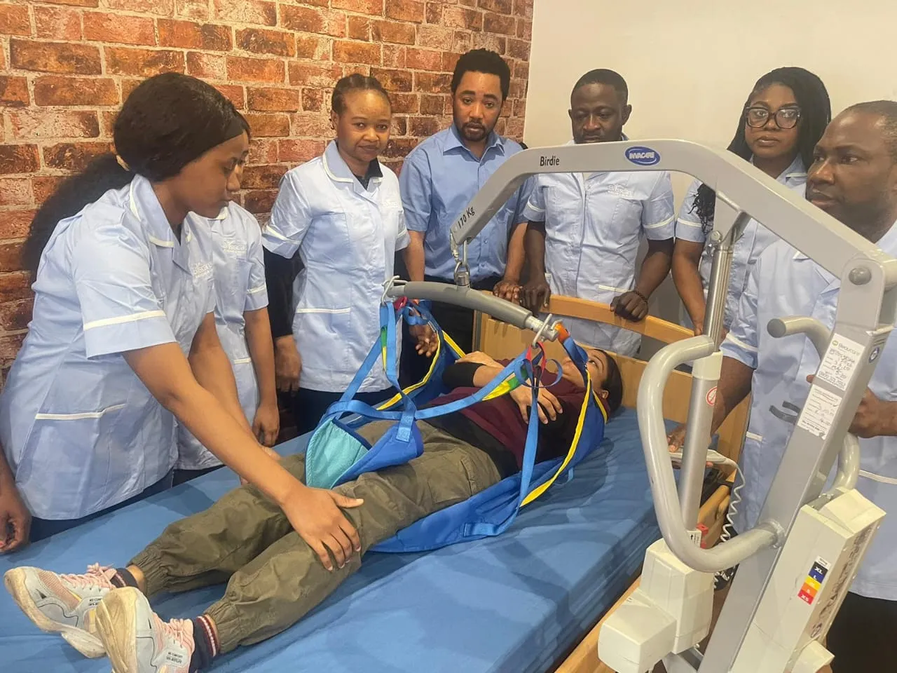 Blisscare staff practising safe moving and handling with a hoist
